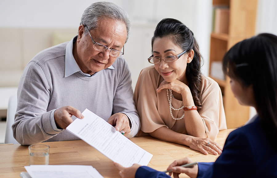 Husband and wife working with a financial planner