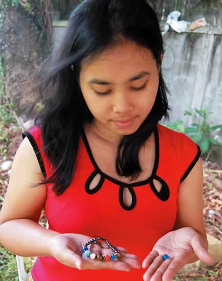Vangie holding an earth bead