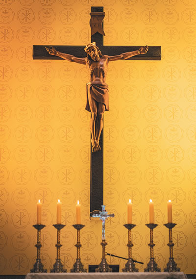Candles in front of a crucifix