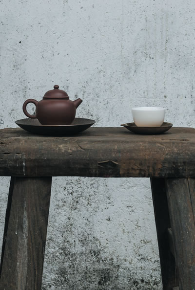 Tea pot and mug on a wooden table