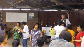Columban Fr. Ed O’Connell and parishioners before Mass