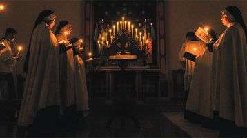 Nuns praying by candlelight in church