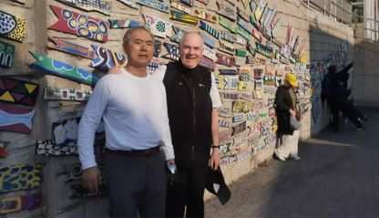 Fr. John Boles and Pelagio in front of one of Gamcheon's murals.