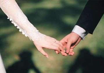 Bride and groom holding hands