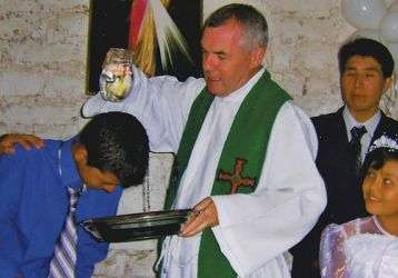 Columban Fr. John Boles Baptizes a chile
