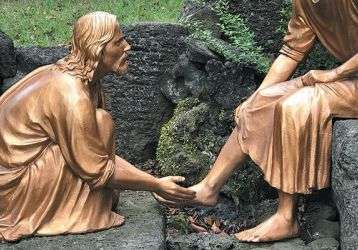 Statue of Jesus washing the feet of one of his apostles