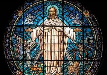 Stained glass window of a compassionate Jesus 