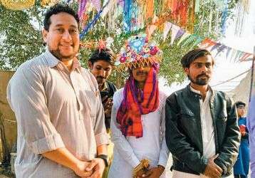 Fr. Pat Visanti (left) dressed in the traditional shalwar kamiz with friends